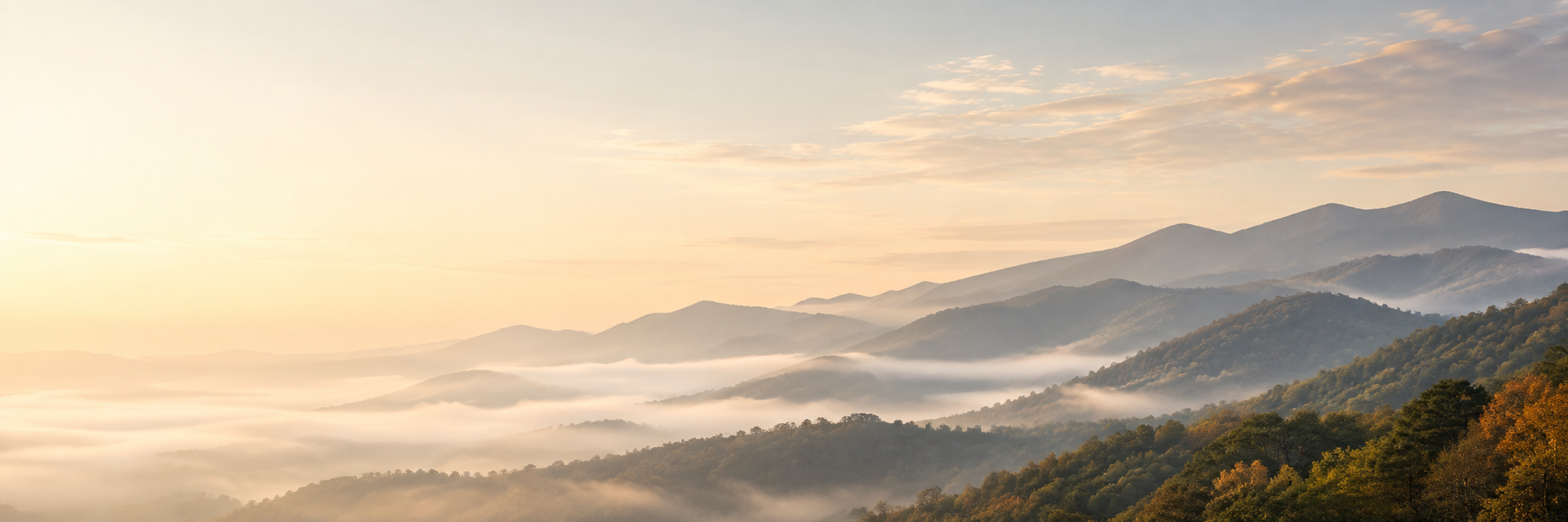 Layered mountain ridges in morning mist